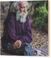 Elderly Man Sits On A Wall Wood Print