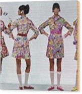 Four Models Wearing Colorful Print Dresses Wood Print