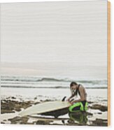 Girl Preparing Surfing Board On Rocky Wood Print