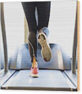 Low Section Of Woman Exercising On Treadmill Wood Print