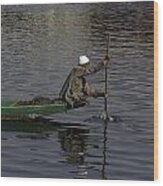 Man Plying A Wooden Boat On The Dal Lake Wood Print