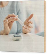 Mature Woman Doing Blood Sugar Test At Home. Wood Print