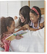 Mother & 2 Kids Lauging & Reading In Bedroom Wood Print