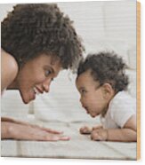 Mother Playing Face To Face With Baby Son On Floor Wood Print