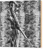 Mountaineer Statue With Black And White Brick Background Wood Print
