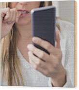 Nervous Young Woman Using Smart Phone Wood Print