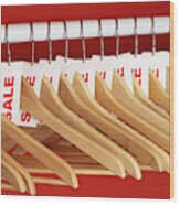 Rail Of Clothes Hangers With Sale Tags Attached, Close-up Wood Print