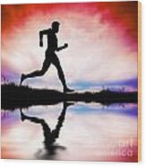Silhouette Of Man Running At Sunset Wood Print