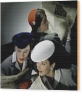 Three Models Wearing Assorted Hats Wood Print