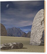 Three Stone Faces Lay Scattered Across A Desert Mountain Landscape Wood Print