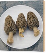 Three Wild Morel Mushrooms On A Plate Wood Print