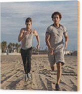 Two Young Friends Jogging At The Beach Wood Print