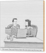 Woman Speaks To Husband As They Sit Behind A Desk Wood Print