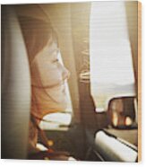 Woman With Hair Blowing Looking Out Window Of Car Wood Print