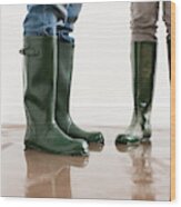 Young Couple In Wellington Boots On Flooded Floor Wood Print