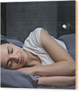 Young Female Sleeping Peacefully In Her Bedroom At Night, Relaxing Wood Print