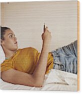 Young Woman Checking Phone In Bunk Bed Wood Print