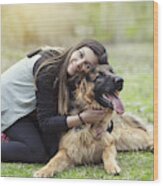 Young Woman Hugging Her German Shepherd In The Park Wood Print