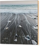 Pebbles In The Beach And Flowing Sea Water Wood Print