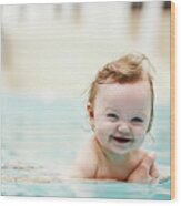 Baby Girl Smiling And Swimming In Water. Wood Print