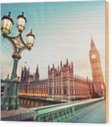 Big Ben, London The Uk At Sunset. Retro Street Lamp Light On Westminster Bridge. Vintage Wood Print