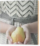 Hands Holding Yellow Pear Wood Print