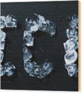 Ice Written With Ice Cubes On Dark Background Wood Print