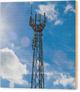 Mobile Phone Mast With A Blue Sky Behind Wood Print