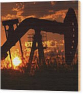 Oil Rig Pump Jack Silhouetted By Setting Sun Wood Print