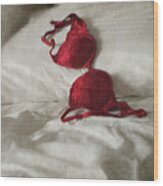 Red Brassiere Laying On Bed Wood Print