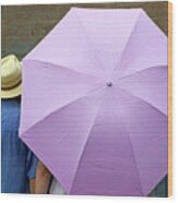 Tourist Looking At A Wall While Sheltering Under An Umbrella Wood Print