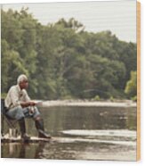 Man Fishing While Sitting On Chair At Lake #1 Photograph by Cavan