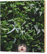 Young Woman Looking Up Against Leafy #1 Wood Print