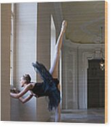 Ballerina Doing Exercise By Window Wood Print