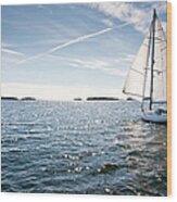 Classic Yacht Sailing Away Against Blue Wood Print
