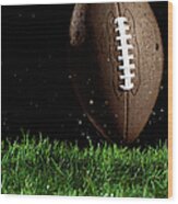 Football In Motion Over Grass Wood Print