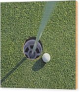 Golf Ball Next To Hole On Golf Course Wood Print