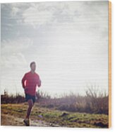 Jogger Running On Muddy Track Wood Print