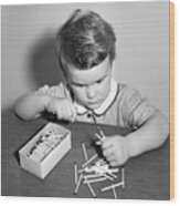 Little Boy Playing With Matches Wood Print