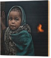 Little-girl-at-the-door---fires-burn-inside-the-house-in-the-dorze-tribe Wood Print