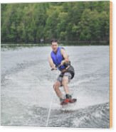 Man Wake Boarding While Being Pulled By A Boat On A Lake. Wood Print