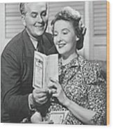 Mature Couple Looking At Brochure, B&w Wood Print
