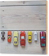 Toy Cars Lined Up In A Row On Floor Wood Print