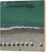 Aerial View From A Flying Drone Of Beach Umbrellas In A Row On An Empty Beach With Braking Waves. Wood Print