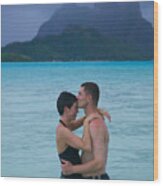A Caucasian Couple Embrace In The Shallow Water At A Tropical Beach Wood Print
