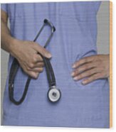 A Female Medical Professional Holds Her Stethoscope In Her Hands Wood Print