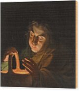 A Man Blowing On A Lamp Wood Print