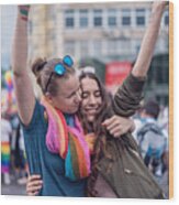 Beautiful Female Couple Hugging While Marching On The Street Wood Print