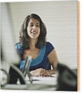Businesswoman In Discussion In Office Smiling Wood Print