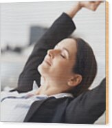 Businesswoman Stretching At Desk Wood Print